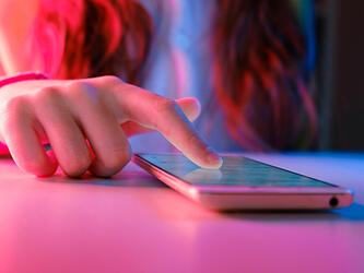 woman's hand scrolling smartphone